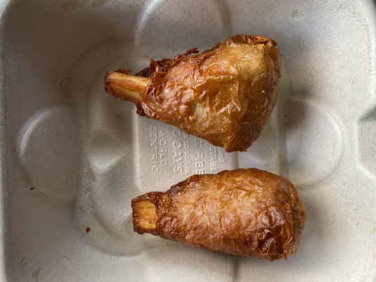 Plant-based chicken drumstick in biodegradable container