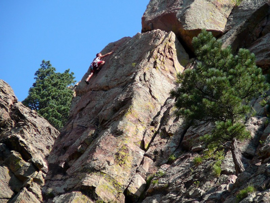 Long rock climber on a vertical surface
